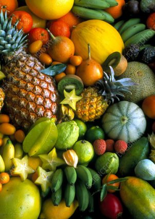 Tropical fruit assortment. View of a wide variety of tropical fruits. Tropical fruits are those which only grow in warm climates. The fruits seen here include pineapples, mangoes, oranges, melons, star fruits, lychees, bananas, kumquats, limes, cape gooseberries, kiwi fruits and papayas. Fresh fruits are a very important dietary source of vitamins (especially A and C) and minerals, including potassium, magnesium and calcium.